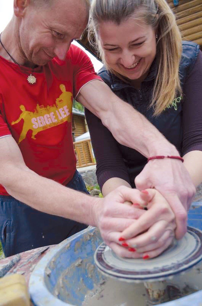 An instructor helps a women make pottery at a 10-day rehabiliation camp in the Carpathian Mountains for war widows and mothers whose sons died in the east Ukraine combat zone financed by the Canada-Ukraine Foundation. in May. 