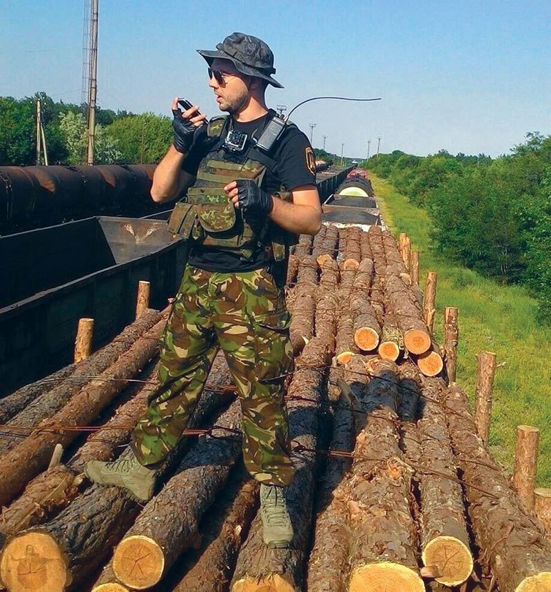 Donbas Battalion soldier Yevhen Shevchenko stands on top of a train car with logs in Luhansk Oblast. The picture was taken in mid-June during an anti-smuggling operation, according to Shevchenko.