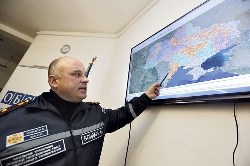 Oleg Bondar, head of the demining department at the State Emergency Service, points to the agency’s electronic Information Management System for Mine Action.