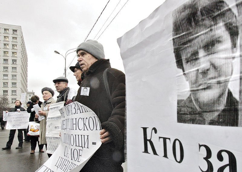 Russian human-rights activists hold portraits of former Russian spy Alexander Litvinenko during their protest in front of the Russian Ministry of Internal Affairs in Moscow on Dec. 15, 2006. (AFP)