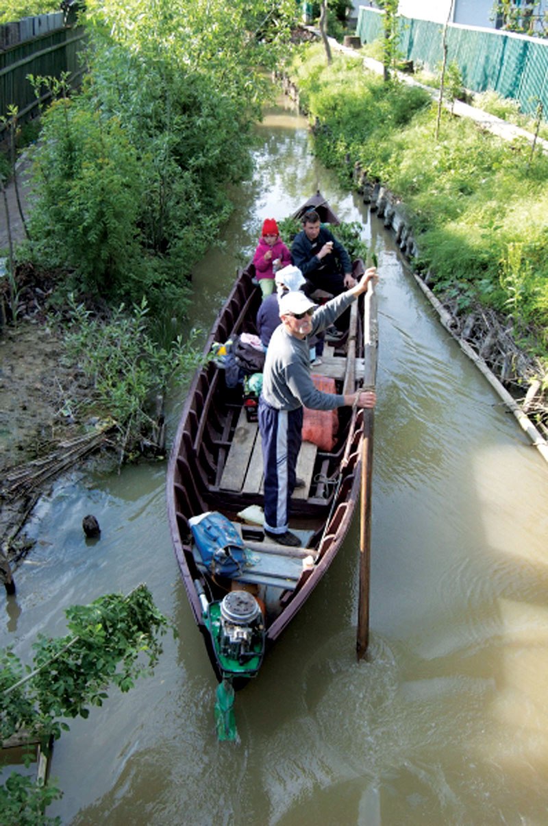 ocals sail a boat on one of town’s canal in Vylkove in Odesa Oblast.