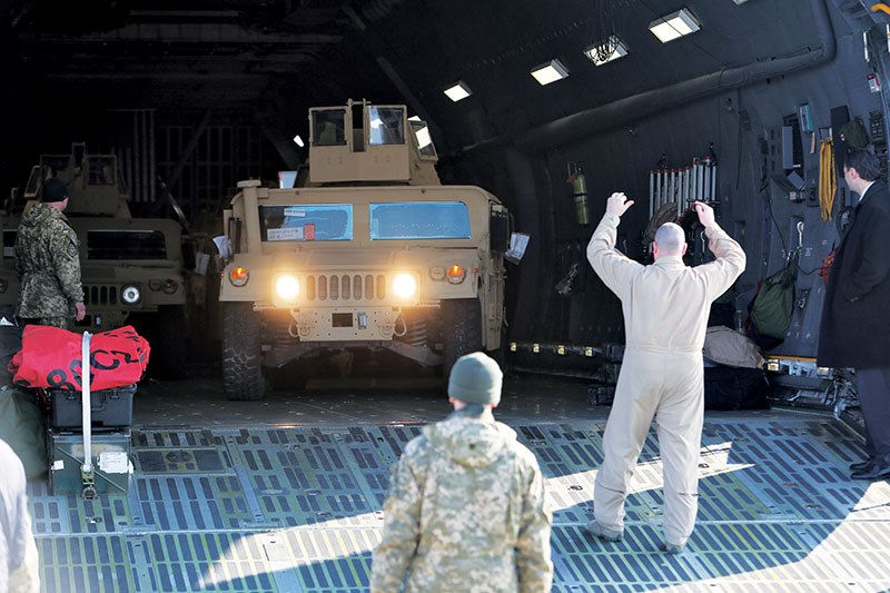 A bulletproof Humvee is driven out of a U.S. military transport plane during the delivery of 10 armored cars at Kyiv Boryspil International Airport on March 25. 