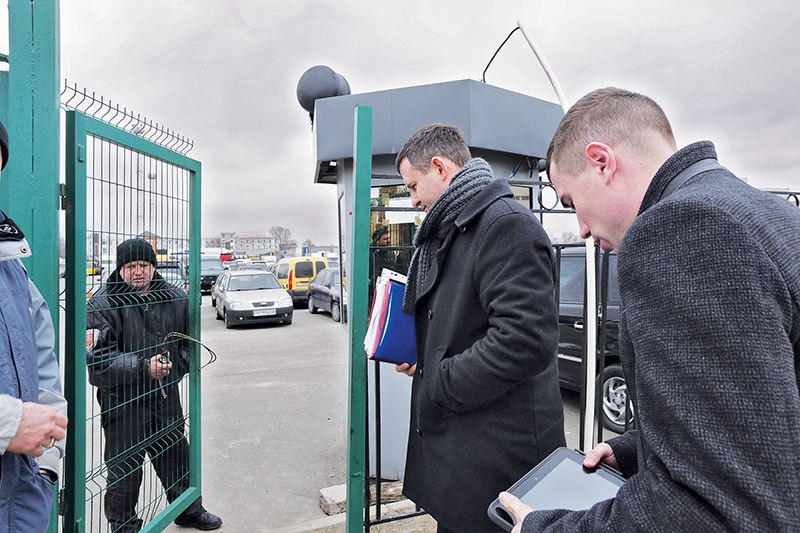  Sergey Makarenko (L) and  Anatoliy  Televskiy, state executors in Kyiv, register a debtor’s car for auction at a state car depot on March, 17. 