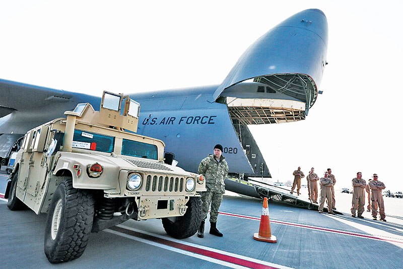 The first of the 10 bulletproof Humvee vehicles supplied by the U.S. drives out of a U.S. military plane at Kyiv Boryspil Internatioanl Airport on March 25, 2015.