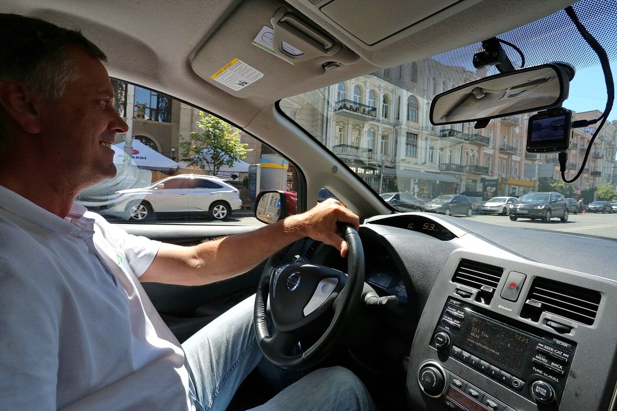 A man drives an Oxy-Taxi cab in Kyiv downtown on July 15.