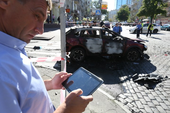 Investigators work near the burnt frame of a car belonged to the Ukrainska Pravda founding editor on July 20. A journalist Pavel Sheremet was killed early on July 20 in a car explosion in the center of Ukraine's capital city of Kyiv.