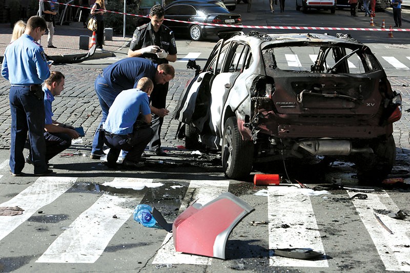 nvestigators work at the scene of the car-bomb explosion in central Kyiv that killed Belarusian journalist Pavlo Sheremet on July 20. He was driving to host his daily radio show in the car of his partner, Ukrainska Pravda news website owner Olena Prytula. The case remains unsolved. (Volodymyr Petrov)
