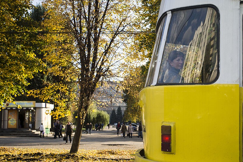 A woman looks through a tram window as autumn falls on Kharkiv on Oct. 7 (Anastasia Vlasova).