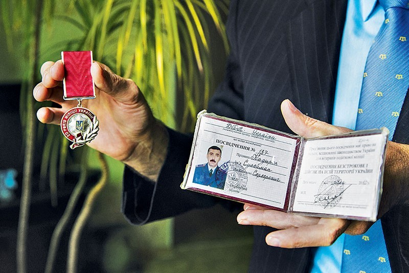 Suleyman Kadyrov, Crimean tatar activist, shows his medal and ID for serving in the Ukrainian police for 20 years on November 17th, 2016. FSB opened criminal case against his on charges of extremism.