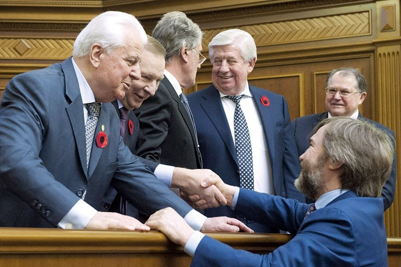 Vadim Novinsky (R) shakes hands on May 8, 2015 with two former Ukrainian presidents, Leonid Kravchuk and Leonid Kuchma, during a special parliament session to commemorate the 70th anniversary of victory against Nazism in Europe. Another former President Viktor Yushchenko talks to then Prosecutor General Viktor Shokin. (UNIAN)
