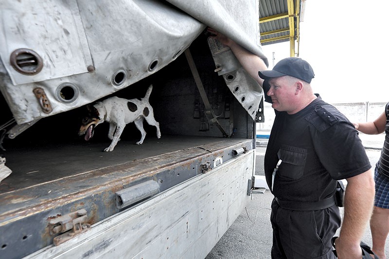 A border guard inspects an empty truck along the Ukraine-Moldova border in August 2016. (Volodymyr Petrov)