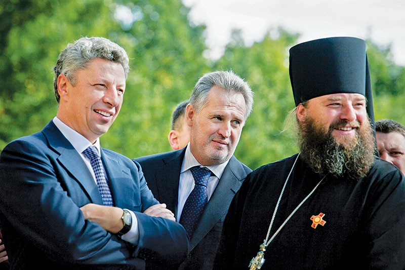 Dmytro Firtash (C) and Energy Minister Yuriy Boyko (L) attend a visit of Russian Orthodox Church Patriarch Kirill to Ukraine’s Bukovyna region on Oct. 3, 2011.