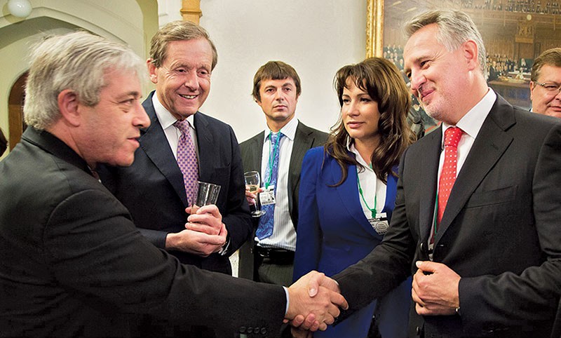 Lord Risby (second from left) watches with Lada Firtash as Dmytro Firtash (R) and the UK House of Commons Speaker John Bercow shake hands during the opening of Firtash’s Days of Ukraine festival at the British parliament on Oct. 17, 2013.