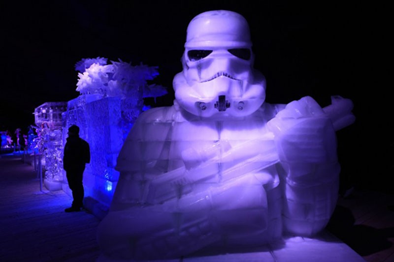 An ice-sculptures in the form of a Stormtrooper from the Star Wars series is displayed during the Star Wars Ice-sculpture festival in Liege on December 16, 2015. The wait is finally over. "Star Wars: The Force Awakens" opens in cinemas in France, South Africa and several other countries, with fans giving their first reaction to the latest episode of the space saga. / AFP PHOTO / JOHN THYS