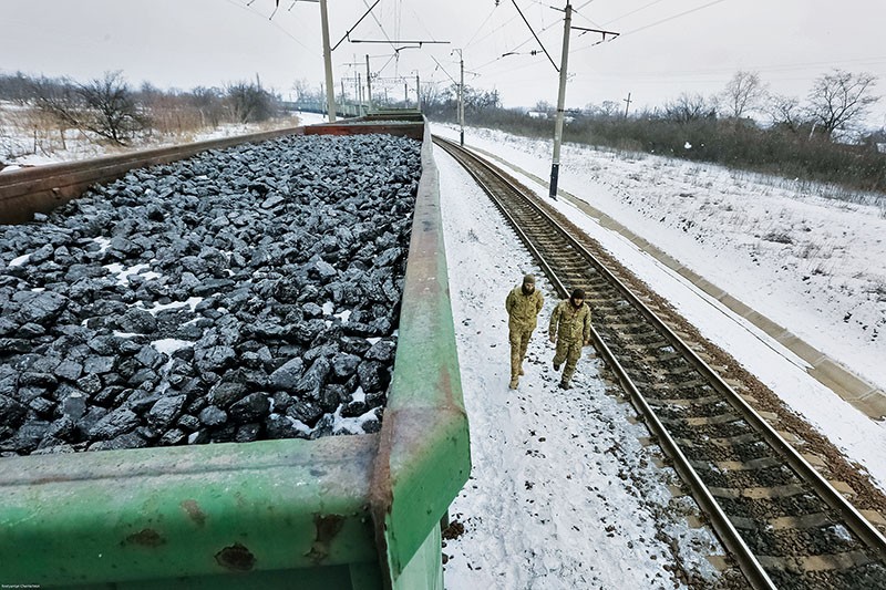 Veterans of Ukraine's ongoing war patrol near the coal train they blockaded traveling from the occupied territories at Kryvy Torets station on Feb. 14, 2017.