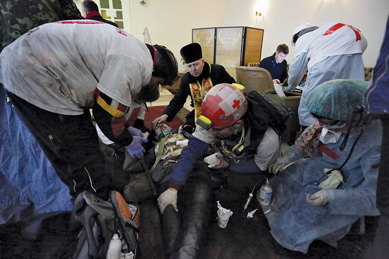 Medics help a wounded activist in Kyiv’s Zhovtnevy Palace on Feb. 20, 2014. (Anastasia Vlasova)
