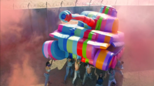 The rainbow-colored inflatable tank is one of the few highlights of the video. (Youtube / Diesel)