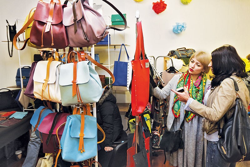 Women look at Ukrainian-made bags during Vsi Svoi festival in Kyiv’s D12 Gallery on March 11. (Kostyantyn Chernichkin)