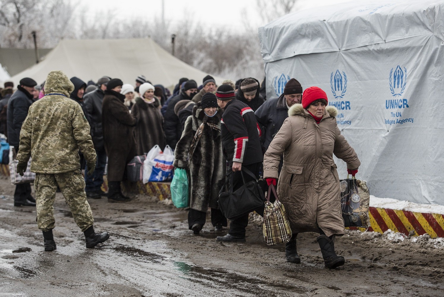 People rush to the bus stop at the border crossing point in Mayorsk, Donetsk Oblast on Dec. 27.