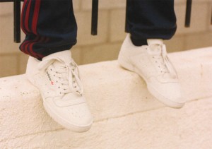 This photograph shows Bogdan wearing Yeezy Powerphase Calabasas, retro model all-white sneakers with red and gold lettering. (Daniel Regan)