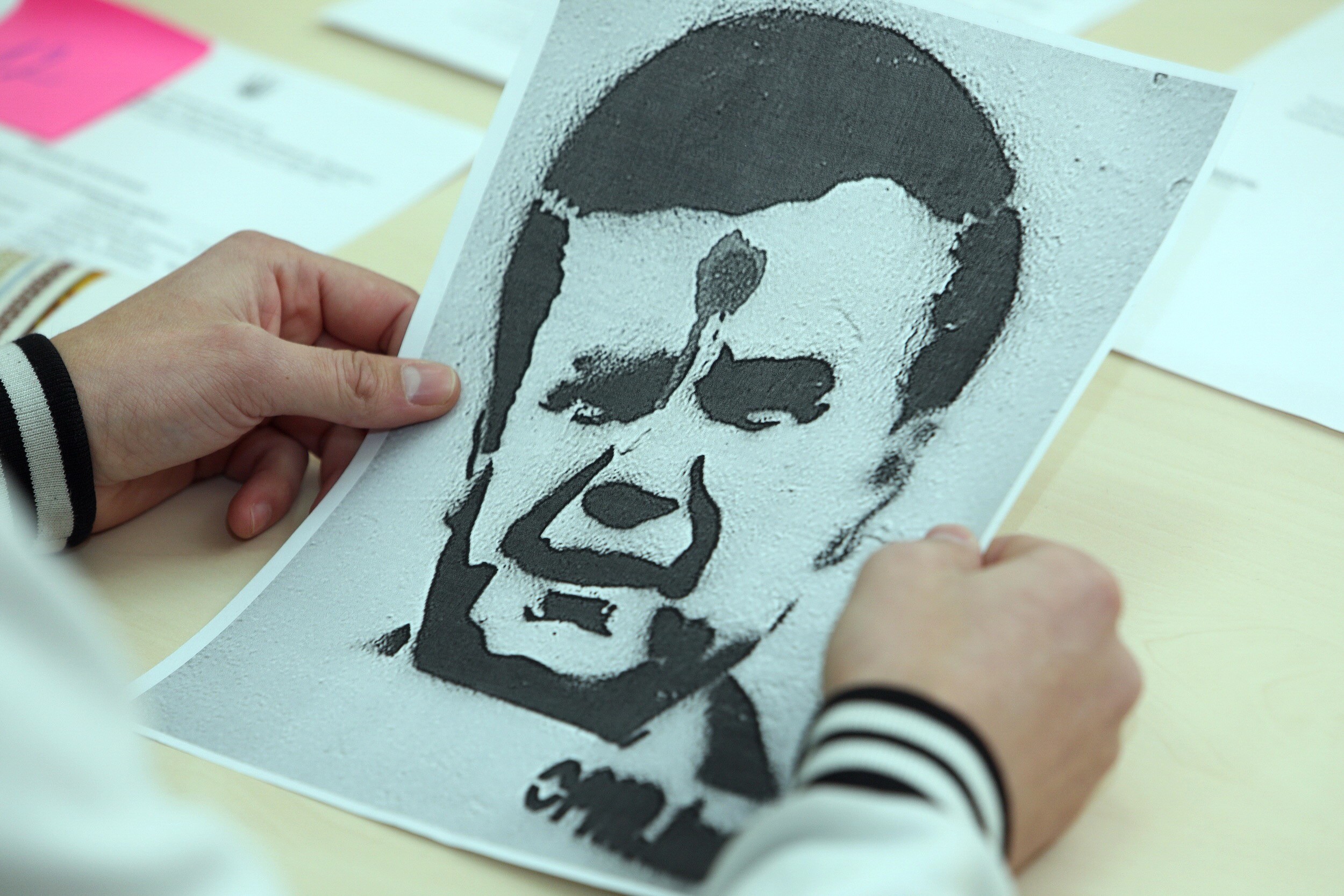 Volodymyr Nykonenko shows an image they drew with stencils back in 2011. 