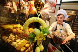 An employee displays an Easter cake at Boulangerie Artisan on April 11.