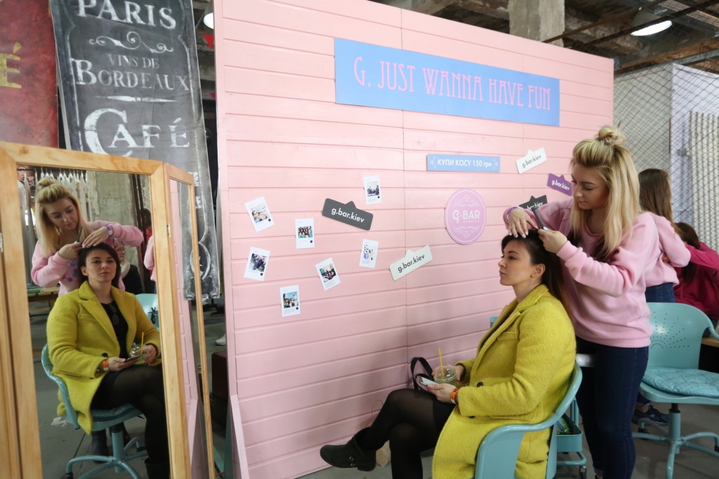 A woman has her hair done at Kurzh Bazar flea market at Platforma Art Factory in Kyiv. (Anastasia Vlasova) 