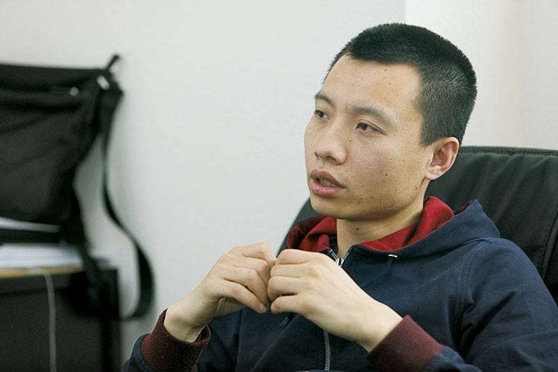 Chinese citizen Peng Tao (R) gestures as he recalls the difficulties he had finding his way around Kyiv upon arrival in 2004. He senses a lack of confidence among Ukrainians about their future and is still unsure about whether he will stay in the country. 