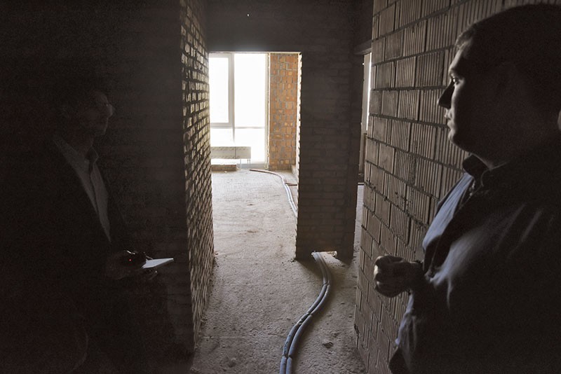 Artem Tikhonov (R) shows the Kyiv Post an empty apartment in the Royal Tower residential complex in central Kyiv. Local agents say such properties see high rental demand after being furnished. (Oleg Petrasiuk)