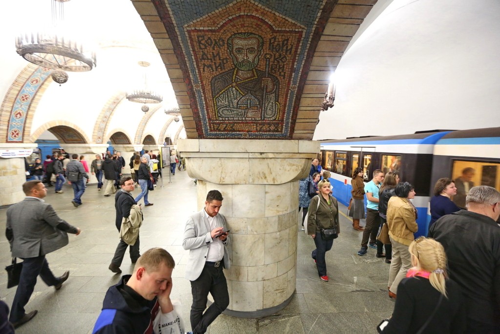 A man checks his phone as he waits for the train at Zoloti Vorota metro station in Kyiv on May 3.