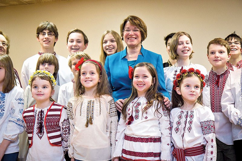 U.S. Sen. Amy Klobuchar (Democrat of Minnesota) poses with Ukrainian-American children after a February town hall meeting in which she discussed her New Year’s Eve trip to the war front in Ukraine. 