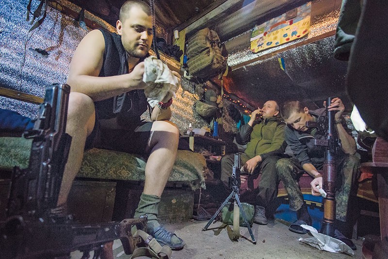 Ukrainian servicemen clean their weapons after a clash with Russian-backed forces in the town of Pisky on May 15. The town, close to the ruins of Donetsk airport, a former Ukrainian stronghold that fell to the enemy in January 2015, is now right on the front line. 