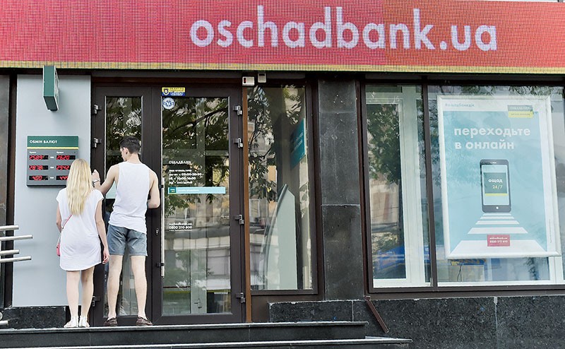 People try to enter a closed branch of Oschadbank on June 27 in Kyiv. Oschadbank had to close its operations on that day due to the virus attack.