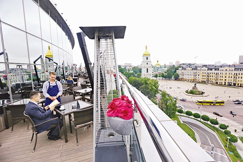 A visitor of the Hyatt Regency Hotel’s Bar on 8 places an order on June 8. The outdoor terrace offers spectacular views of the St. Sophia and St. Michael’s cathedrals in central Kyiv. 