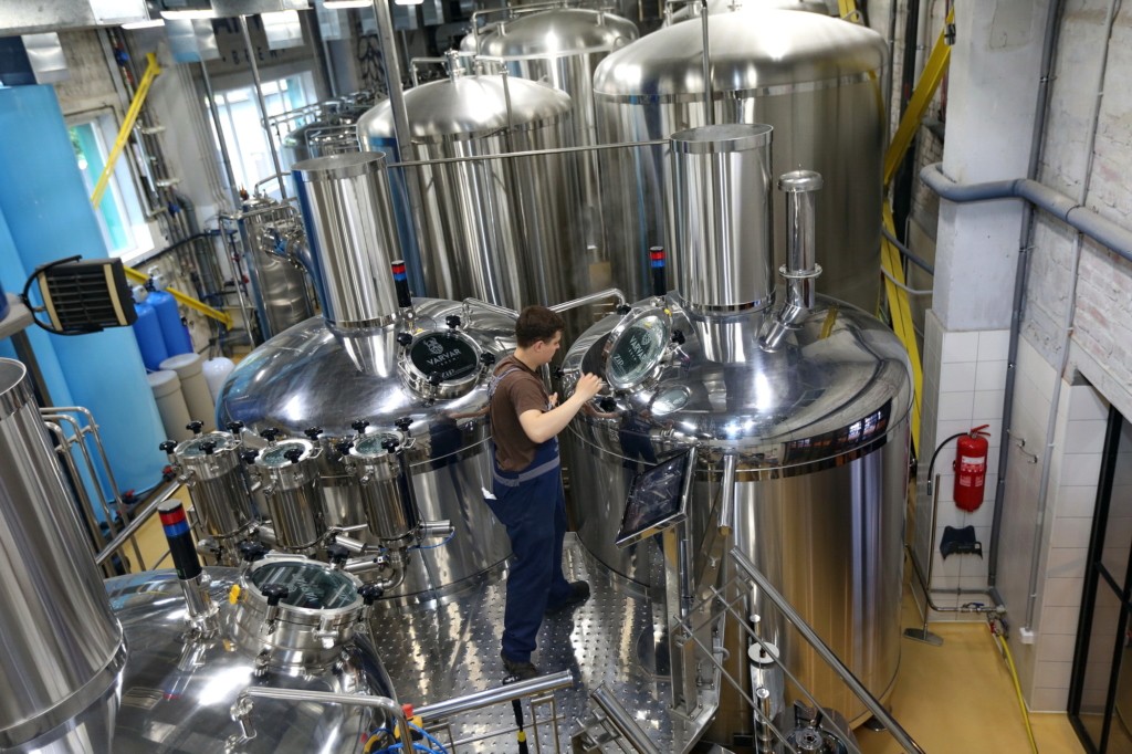 A worker at Varvar's Kyiv factory inspects a brewing tank on June 1. The company recently had to expand its brewery amid increased demand for craft beer. 