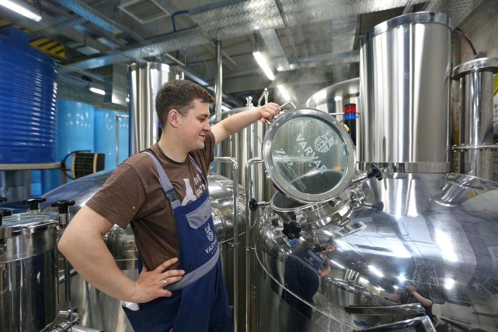 A worker at Varvar's Kyiv factory inspects a brewing tank on June 1. The company recently had to expand its brewery amid increased demand for craft beer. (Kostyantyn Chernichkin)