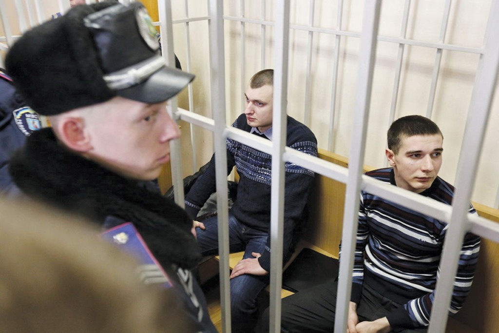 Former Berkut police officers sit in the caged dock of Pechersk District Court in Kyiv on February 16, 2015. (Volodymyr Petrov)