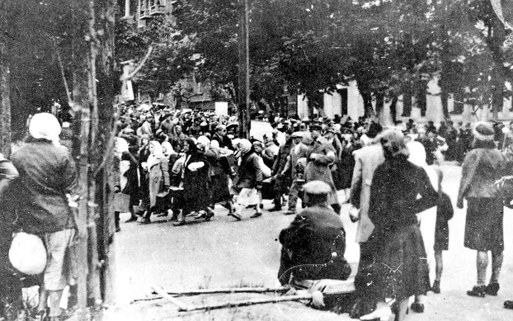 Ostarbeiters, the German word for “Eastern Workers,” or slave workers taken from eastern and central Europe to work in German factories, gather on a street in Kyiv in 1942. (Courtesy of the Kyiv History Museum)