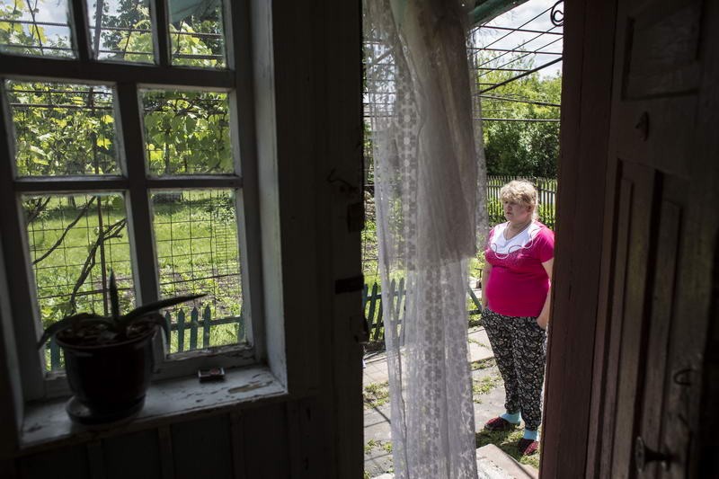 Olena Sugak, 53, whose son Ruslan went missing in action in August 2014, stands in the yard of her house in the village of Khrystophorivka of Dnipropetrovsk Oblast. 