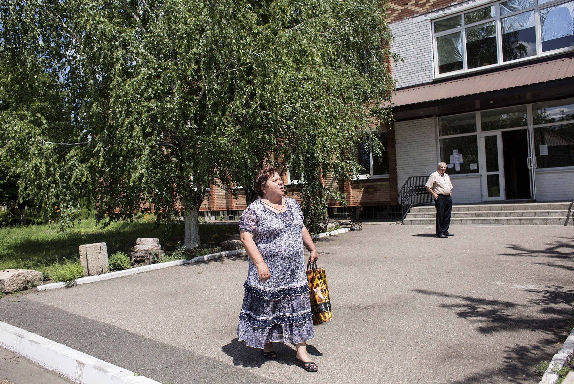 Nadiya Zosimova and Volodymyr Kamarali say goodbye to each other near the Palace of Culture in Kamianka.