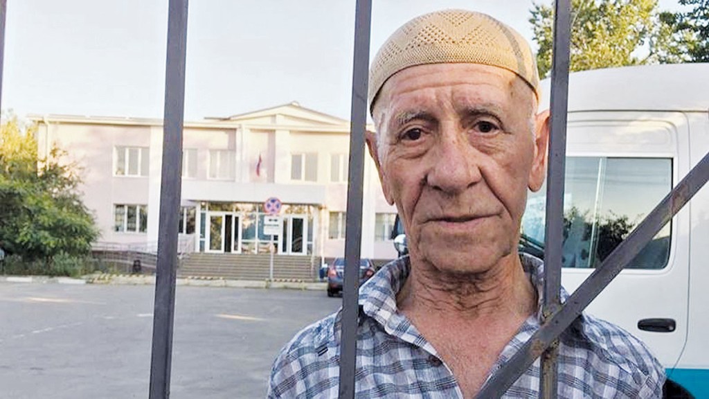 Server Karametov, a 76-year-old Crimean Tatar, came to the Simferopol District Court with a sign that reads “Putin! Our children are not terrorists.” He was arrested, jailed and fined for “disobeying the police” on Aug. 9. 