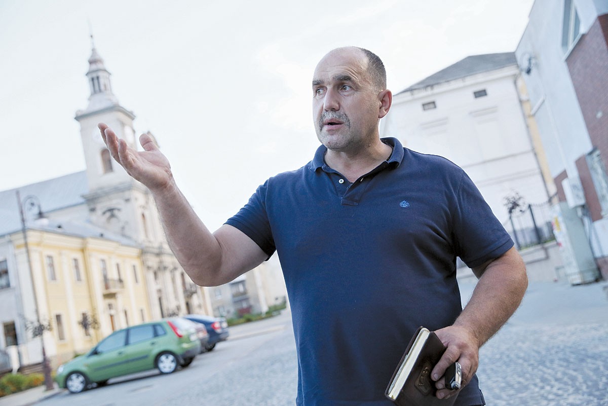 Zolochiv Mayor Igor Grynkiv shows recent renovations of the city on Aug. 2. The city still needs $1 million to finish the reconstruction of its central square.