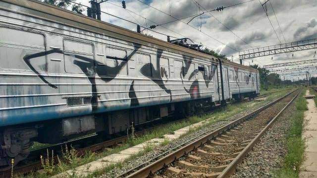 A photo of a suburban train, newly painted with graffity. A gang of 50 street artists halted a suburban train at a train station in Kyiv for 25 minutes and painted eight wagons of the train with graffiti on Aug.7.