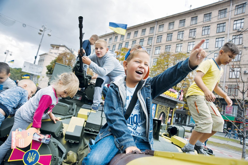 Children play on a tank during an arms exhibition on Aug. 23 in Kyiv. 
