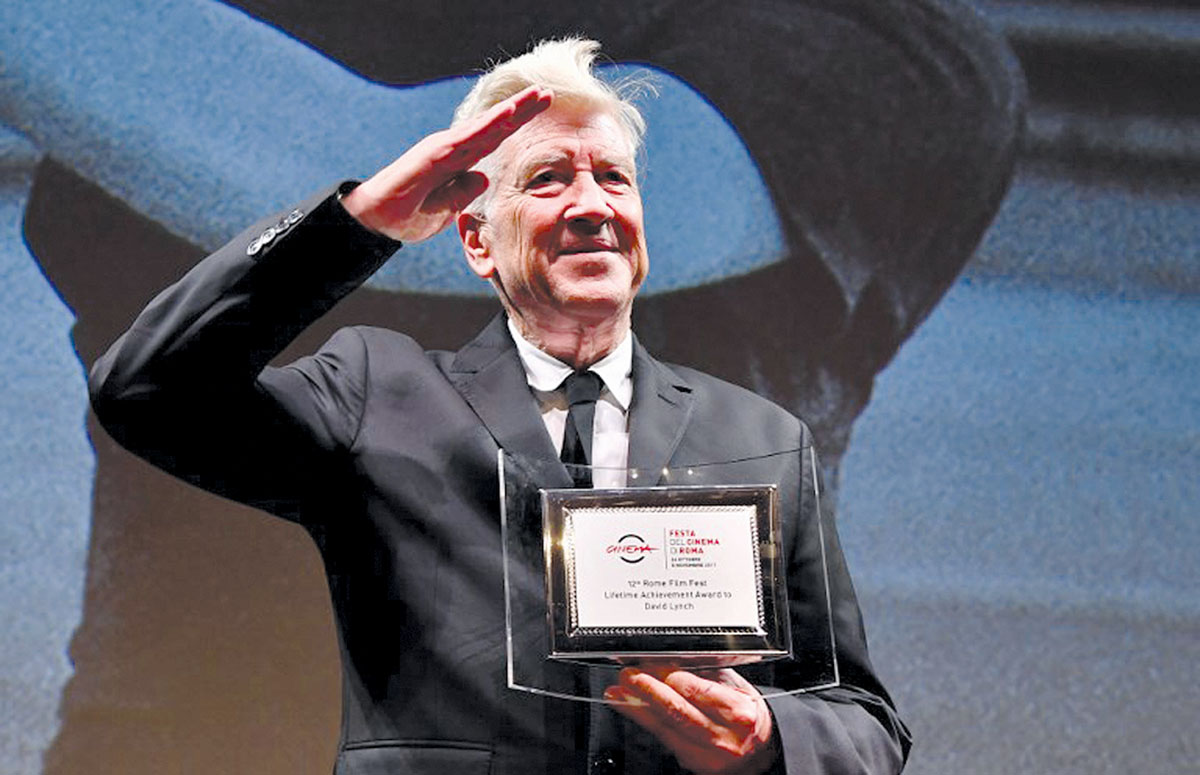 US director David Lynch salutes after receiving a lifetime achievement award during the 12th Rome Film Festival on November 4, 2017 in Rome. (AFP)