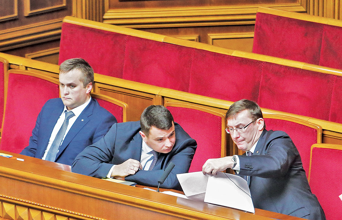 Prosecutor General Yuriy Lutsenko (R) with Artem Sytnyk, head of the National Anti-Corruption Bureau (C), and Nazar Kholodnytsky, the chief anti-corruption prosecutor (L), in parliament on July 5. Lutsenko has lashed out at Sytnyk as the authorities try to restrict the NABU's independence. (Volodymyr Petrov)