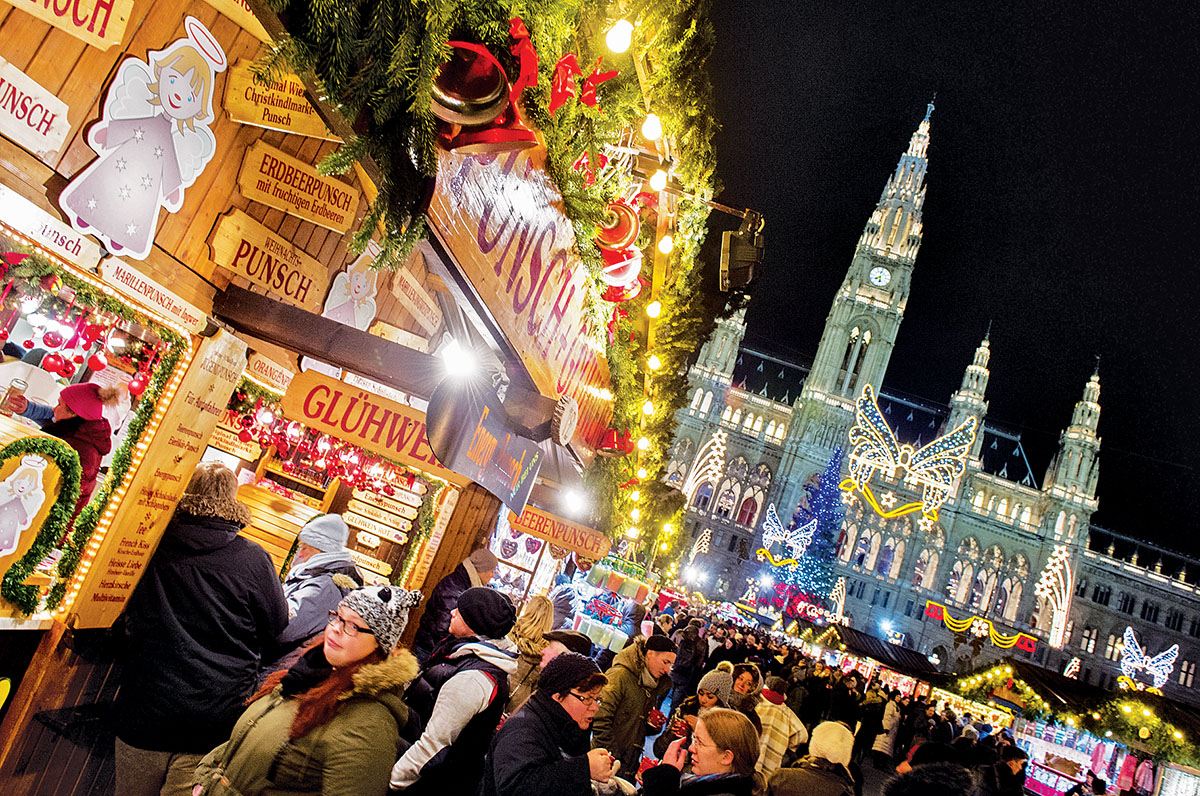 People crowd the Christmas market in front of Vienna's City Hall on Nov. 26, 2015 after Vienna officially lit up the city for the upcoming Christmas season.