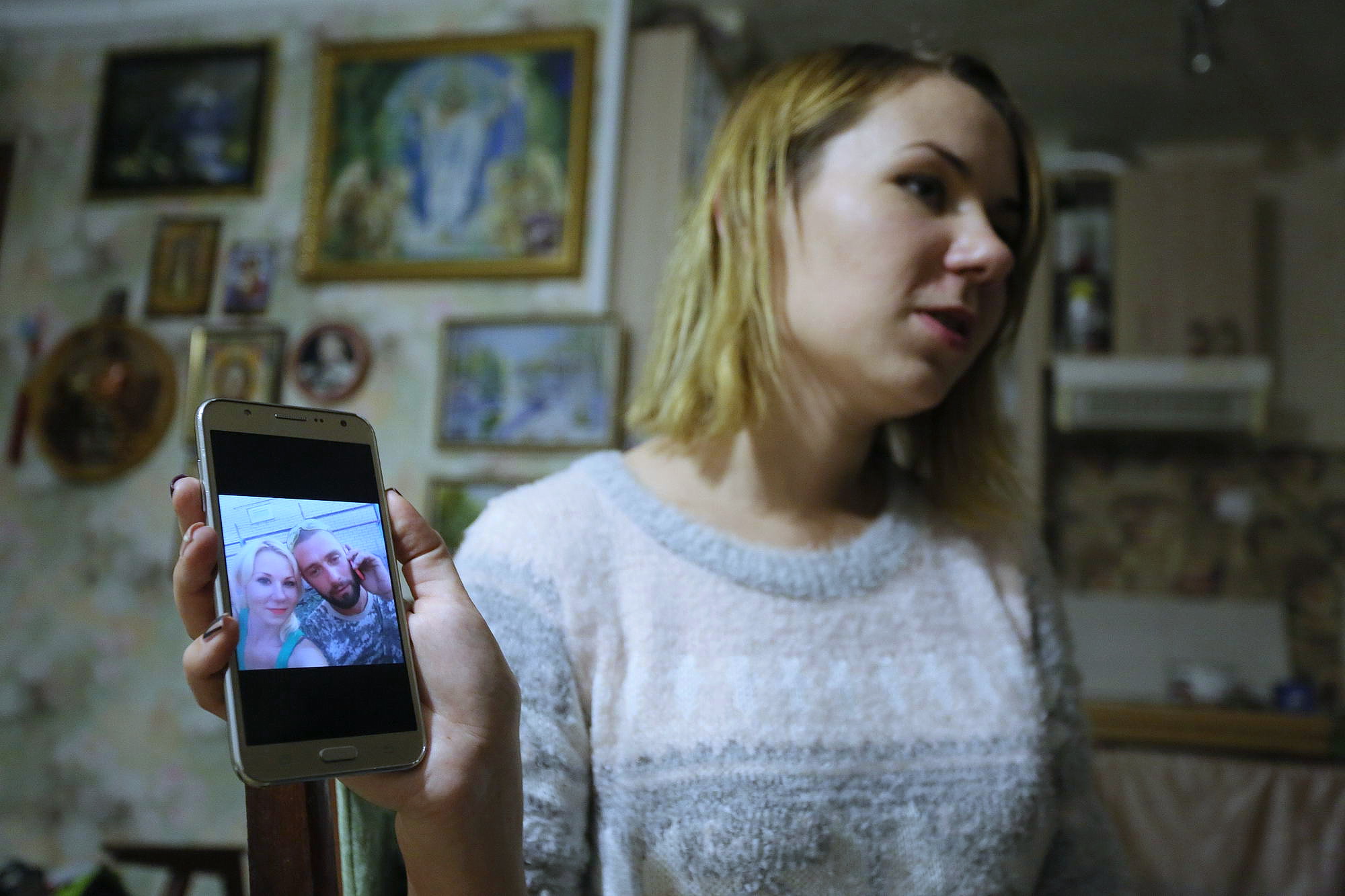 Alyona Iovova shows a picture of her brother Mykola, taken captive with fellow soldier Oleksiy Kodman near Pavlopil in Donetsk Oblast in November 2015. (Oleg Petrasiuk)