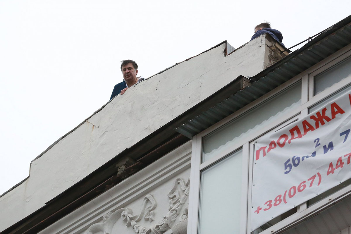 Ex-Georgian President Mikheil Saakashvili stands on the roof of his apartment building on Dec. 5 during an attempt by authorities to arrest him. His supporters blocked police and freed him from custody. (UNIAN)