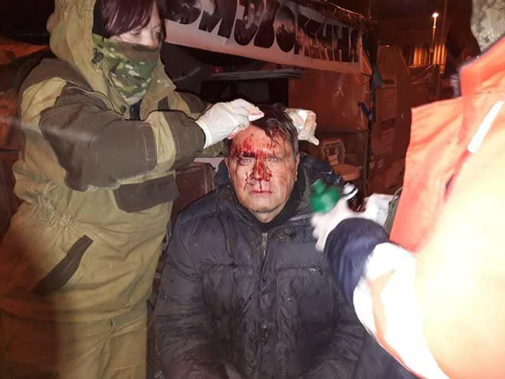 A protester with a bloodied head after the Dec. 6 attempt by the police to storm the protest camp. 